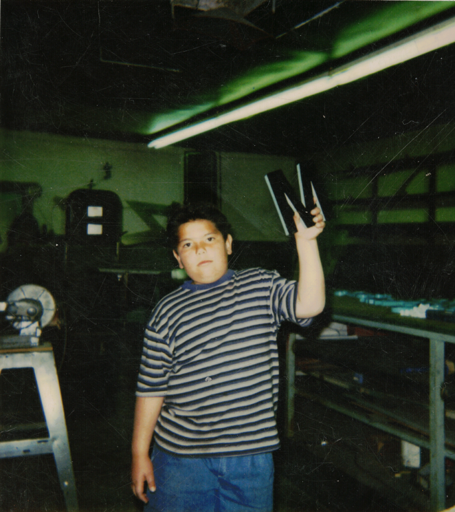 Miguel in his father's sign shop